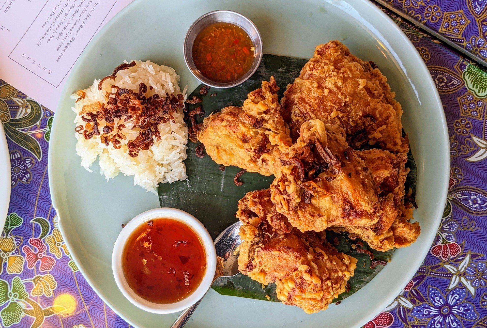 Plate of fried chicken on a colorful tablecloth at Anajak Thai
