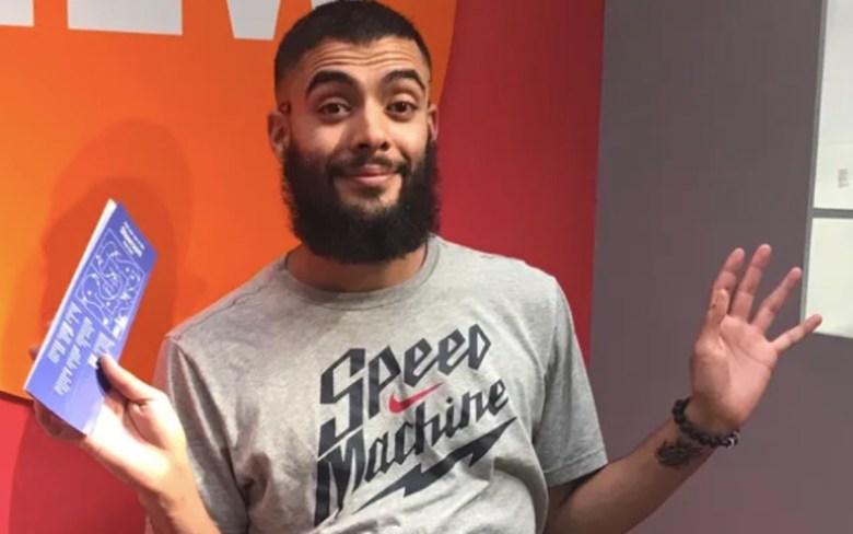 A man, Arthur Jordan, holding up his hands in a casual photo.