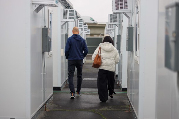 Mayor Kevin McCarty, left, tours new tiny homes alongside an assistant at the Roseville Road shelter campus for the unhoused which just added 135 new homes. Douglas Carter, OBSERVER 