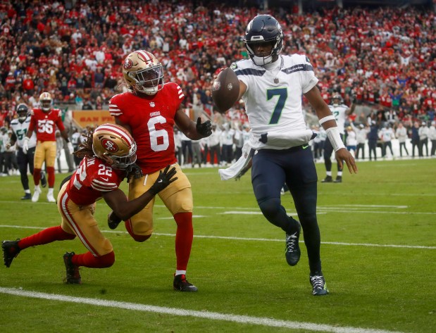 Seattle Seahawks starting quarterback Geno Smith (7) scores the game-winning touchdown against San Francisco 49ers' Malik Mustapha (6) and San Francisco 49ers' Isaac Yiadom (22) late in the fourth quarter at Levi's Stadium in Santa Clara, Calif., on Sunday, Nov. 17, 2024. (Nhat V. Meyer/Bay Area News Group)
