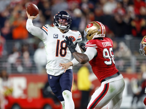 Chicago Bears starting quarterback Caleb Williams (18) throws under presssure against San Francisco 49ers' Clelin Ferrell (96) in the fourth quarter at Levi's Stadium in Santa Clara, Calif., on Sunday, Dec. 28, 2025. (Nhat V. Meyer/Bay Area News Group)