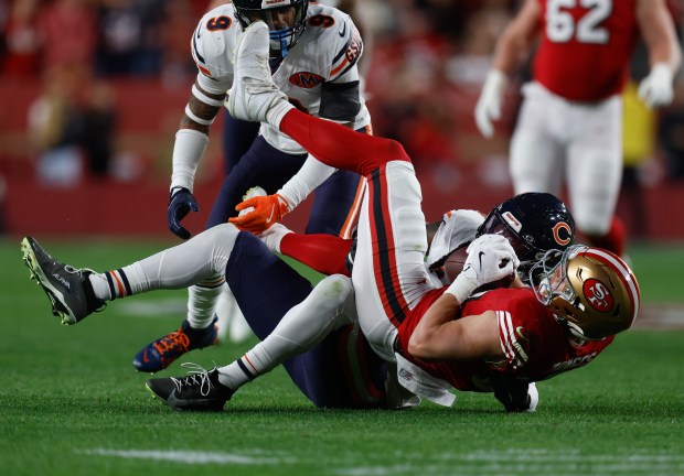 San Francisco 49ers' Jake Tonges (88) comes down with a pass against Chicago Bears' Tremaine Edmunds (49) in the first quarter at Levi's Stadium in Santa Clara, Calif., on Sunday, Dec. 28, 2025. (Nhat V. Meyer/Bay Area News Group)