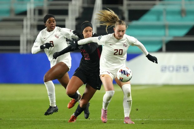 KANSAS CITY, MISSOURI - DECEMBER 08: Defender Heather Gilchrist #20 of the Florida State Seminoles controls the ball against midfielder Jasmine Aikey #12 of the Stanford Cardinal in the first half of the NCAA Division I Women's Soccer Championships at CPKC Stadium on December 08, 2025 in Kansas City, Missouri. (Photo by Ed Zurga/Getty Images)