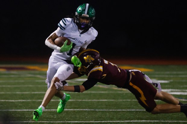 El Cerrito's Gary Youngblood (1) runs with the ball against Menlo-Atherton's Lucca Keighery (3) during the NorCal Division 4-A championship at Menlo-Atherton High School in Atherton, Calif., on Saturday, Dec. 6, 2025. (Shae Hammond/Bay Area News Group)