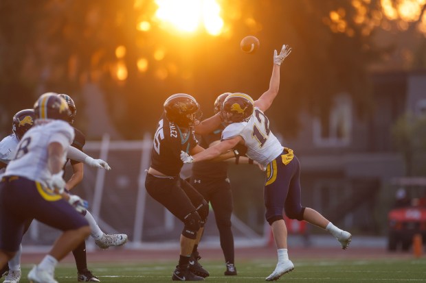 Lincoln's Hudson Buzzard (12) jumps to block the ball against Valley Center's Dilan Gonzalez (75) in the second quarter during Division 6-AA state football championship game at Fullerton Union High School District Stadium in Fullerton, Calif., on Friday, Dec. 12, 2025. (Shae Hammond/Bay Area News Group)
