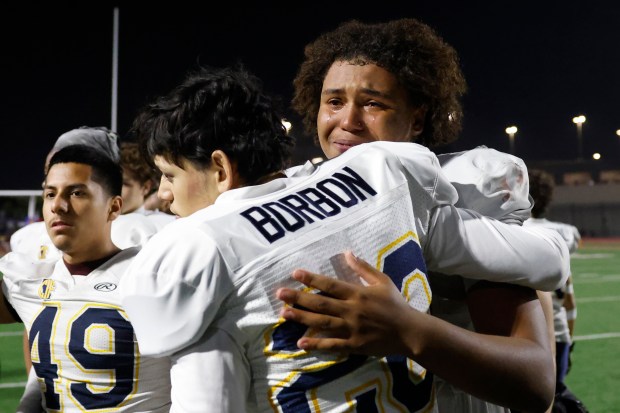 Lincoln's Jaymes Purvis III (8) cries while with Lincoln's Antonio Borbon (20) after losing against Valley Center during Division 6-AA state football championship game at Fullerton Union High School District Stadium in Fullerton, Calif., on Friday, Dec. 12, 2025. (Shae Hammond/Bay Area News Group)