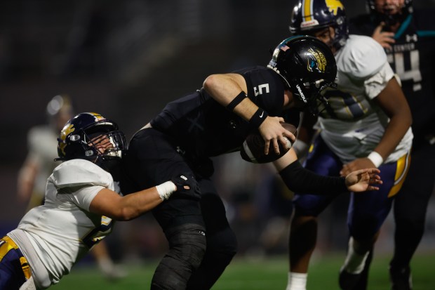 Lincoln's Urian Ramirez (2) and Lincoln's Mykell Munro (90) tackle Valley Center's Braylon Mitchell (5) in the fourth quarter during Division 6-AA state football championship game at Fullerton Union High School District Stadium in Fullerton, Calif., on Friday, Dec. 12, 2025. (Shae Hammond/Bay Area News Group)