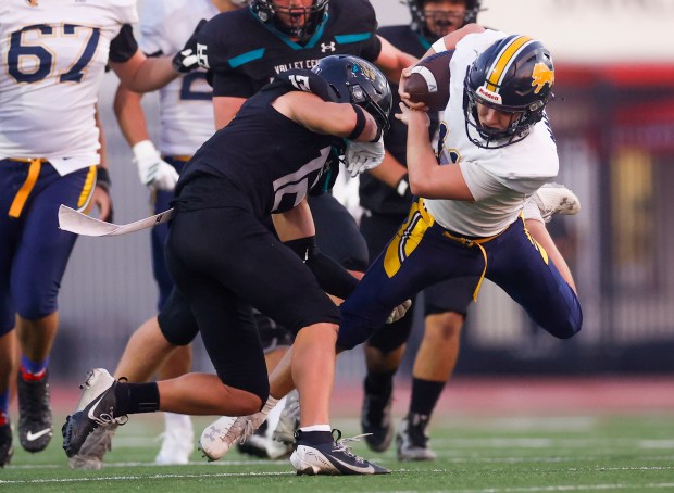 Lincoln's Lucas Martinez (11) runs with the ball against Valley Center's Joaquin Stehly (12) in the second quarter during Division 6-AA state football championship game at Fullerton Union High School District Stadium in Fullerton, Calif., on Friday, Dec. 12, 2025. (Shae Hammond/Bay Area News Group)
