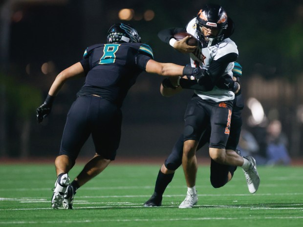 McClymonds' Berell Staples (1) runs with the ball against Kennedy-Delano's Alejandro Ramoz (8) and Kennedy-Delano's Anthony Lara (25) in the fist quarter during the Division 3-A state championship football game at Fullerton Union High School District Stadium in Fullerton, Calif., on Saturday, Dec. 13, 2025. (Shae Hammond/Bay Area News Group)
