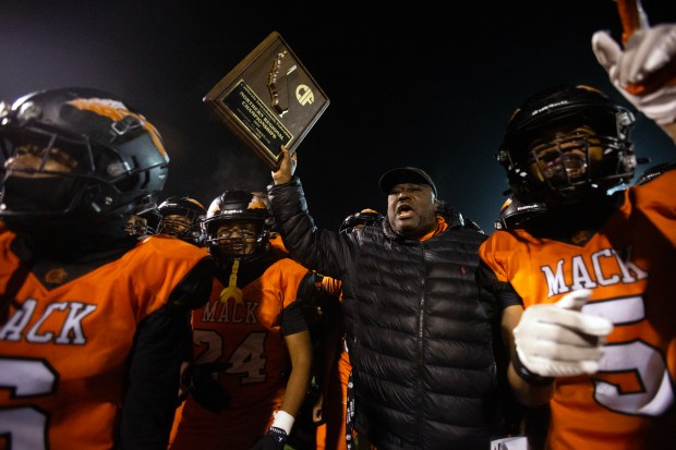 McClymonds head coach Michael Peters holds up the winner's trophy following his team's 42-35 victory over Roseville in a CIF NorCal Division 3-A high school football championship game, Saturday, Dec. 6, 2025 in Oakland, Calif. (D. Ross Cameron for the Bay Area News Group)