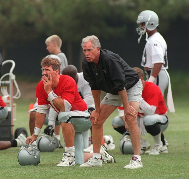 Raiders Head Coach Mike White talks with Quarterback Jeff Hostetler during training camp in Oxnard on July 25, 1995. (Contra Costa Times/Karl Mondon)1995
