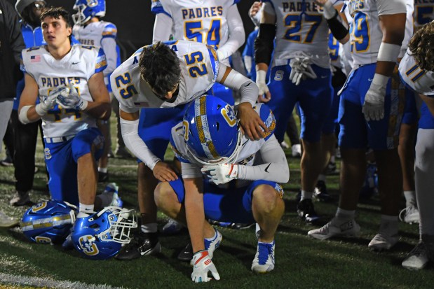 Serra's Robert Vlazny (25) consoles teammate Charles Walsh (1) after being defeated by Saint Mary's during their CIF NorCal Division 2-AA Championship game at Saint Mary's High School in Stockton, Calif., on Friday, Dec. 5, 2025. Saint Mary's defeated Serra 31-24. (Jose Carlos Fajardo/Bay Area News Group)