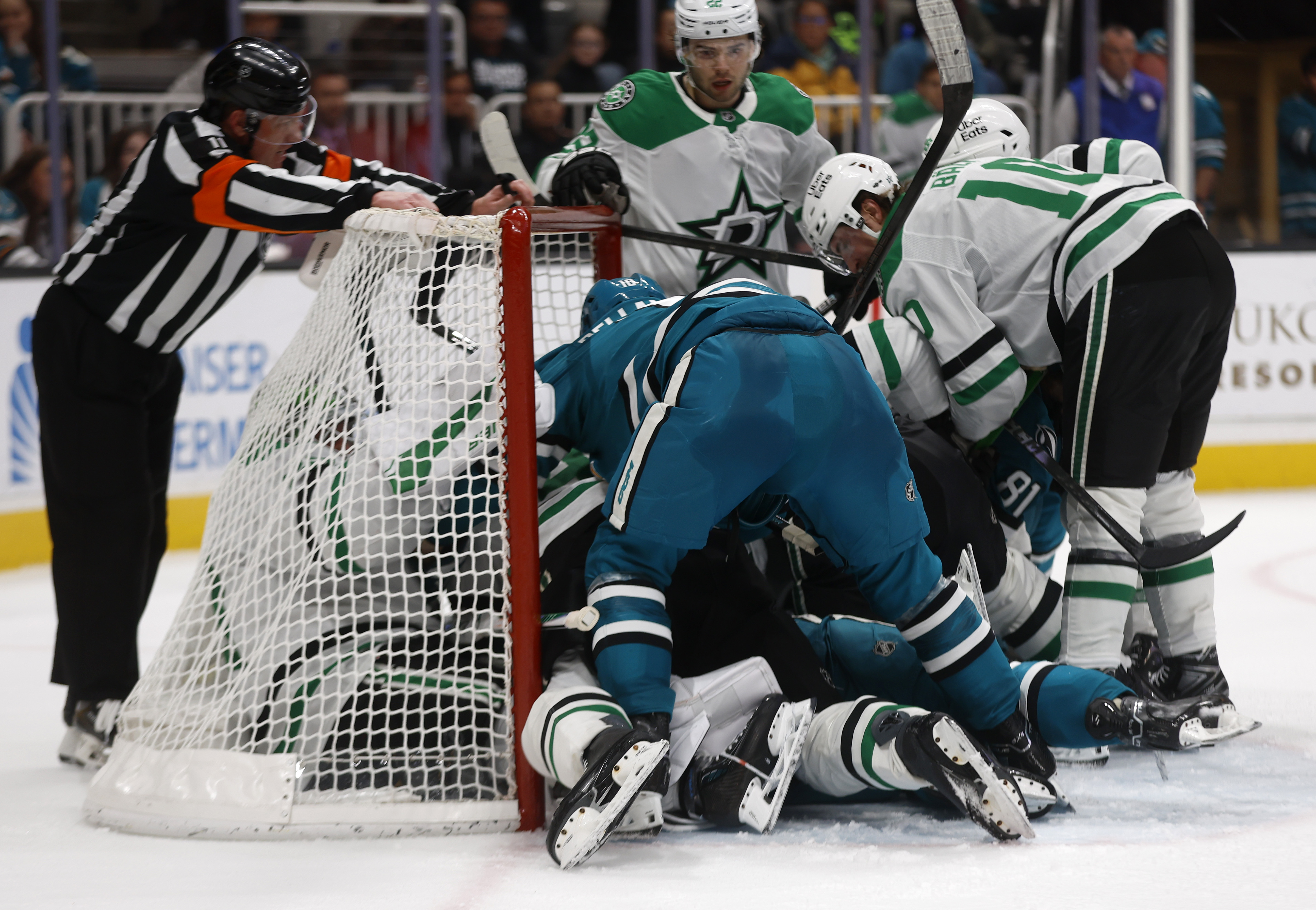 The San Jose Sharks fight for the puck against the...