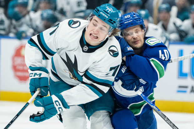 San Jose Sharks' Macklin Celebrini (71) and Vancouver Canucks' Elias Pettersson (40) collide during the first period of an NHL hockey game in Vancouver, British Columbia, Saturday, Dec. 27, 2025. (Ethan Cairns/The Canadian Press via AP)