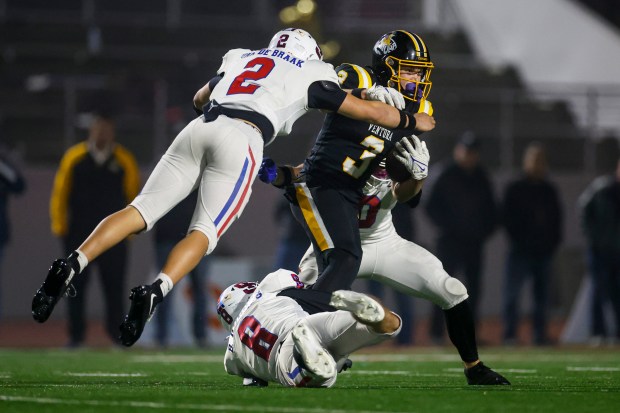 St. Ignatius' Luke Van De Braak (2), St. Ignatius' Brady Hughes (8), and St. Ignatius' Jack Farrell (0) tackle Ventura's Jack Cunningham (3) in the first quarter during Division the 3-AA state championship football game at Fullerton Union High School District Stadium in Fullerton, Calif., on Friday, Dec. 12, 2025. (Shae Hammond/Bay Area News Group)