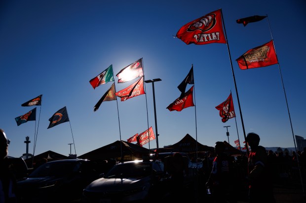 Flags sit above fans as they tailgate before the Bears play the 49ers on Sunday, Dec. 28, 2025, at Levi's Stadium in Santa Clara, Calif. (Armando L. Sanchez/Chicago Tribune)