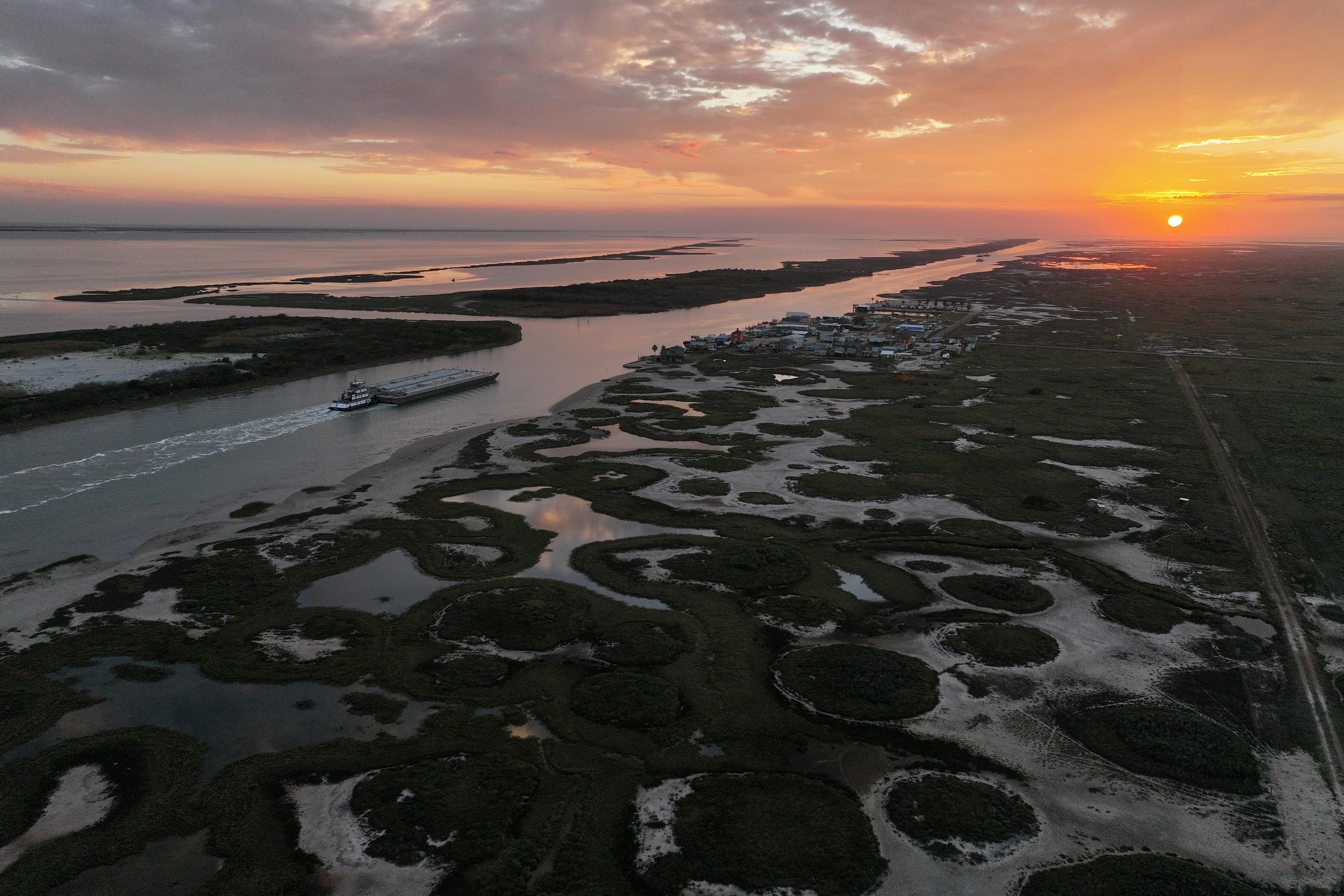 A barge moves along the Intracoastal Waterway beside the Wolfberry...