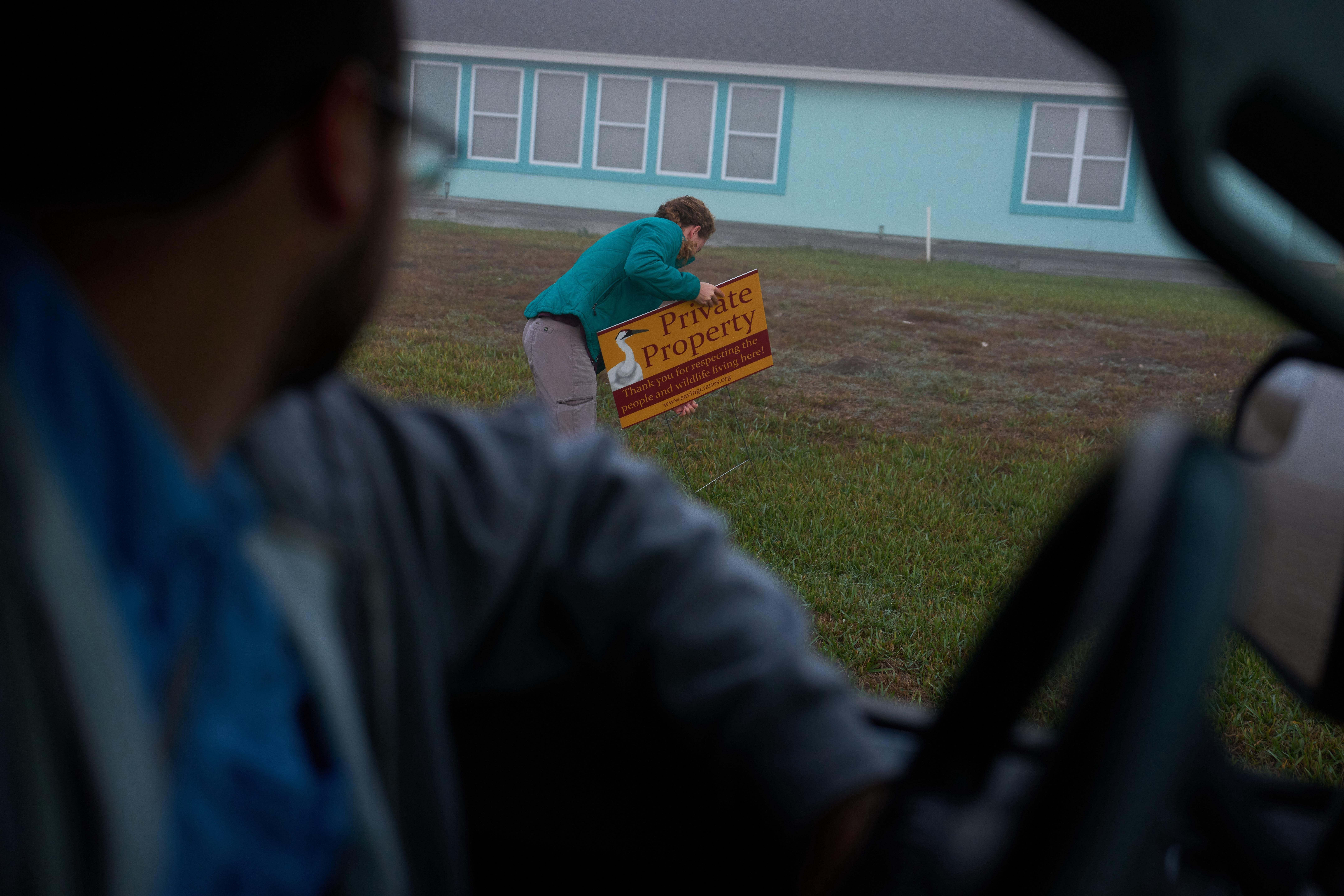 Katie Fernald, Wetland/Rangeland Ecologist with the International Crane Foundation, fixes...