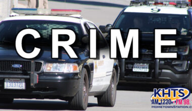 crime arrest -- two Sheriff vehicles driving to the left. Overlaid "Crime" written in white capital letters with a KHTS Logo