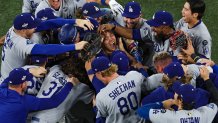 TORONTO, ONTARIO - NOVEMBER 02: Pitcher Yoshinobu Yamamoto #18 of the Los Angeles Dodgers (R) celebrates with teammates after defeating the Toronto Blue Jays, 5-4, in game seven of the 2025 World Series at Rogers Center on November 02, 2025 in Toronto, Ontario. (Photo by Patrick Smith/Getty Images)