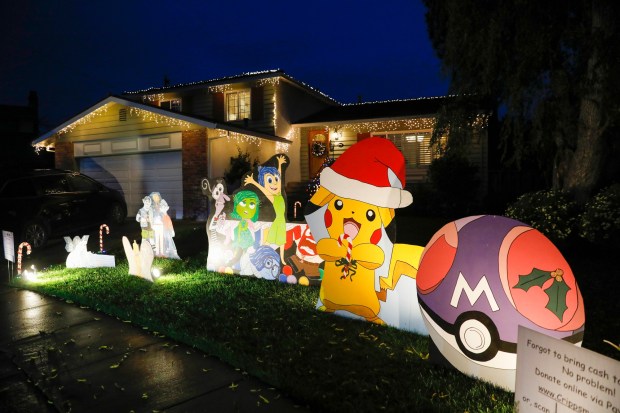 FREMONT, CALIFORNIA - DECEMBER 12: Plywood cutouts of cartoon characters in front of a house at "Crippsmas Place," a neighborhood Christmas lights display, along Wellington Place in Fremont, Calif., on Sunday, Dec. 12, 2021. (Nhat V. Meyer/Bay Area News Group)