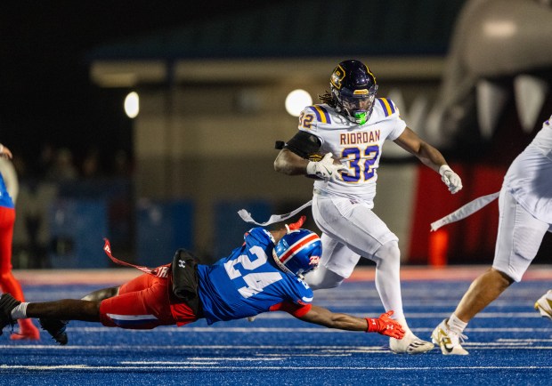 Riordan Crusaders running back Adonyae Brown (32) escapes Folsom Bulldogs strong safety Daniel Eagleton (24) on his way to a long touchown In a CIF Northern California Regional Division 1-AA football championship game in Folsom on Friday, Dec. 5, 2025. (Nathaniel Levine/The Sacramento Bee)