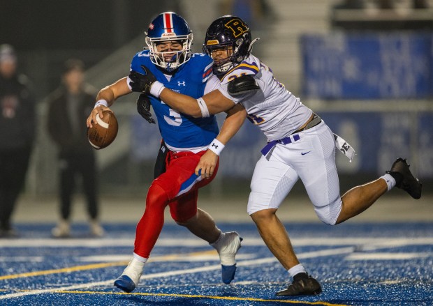 Folsom Bulldogs quarterback Ryder Lyons (3) is sacked in the second quarter by Riordan Crusaders defensive end Zachary Kleppin (21) in the CIF Northern California Regional Division 1-AA football championship game in Folsom on Friday, Dec. 5, 2025. (Nathaniel Levine/The Sacramento Bee)