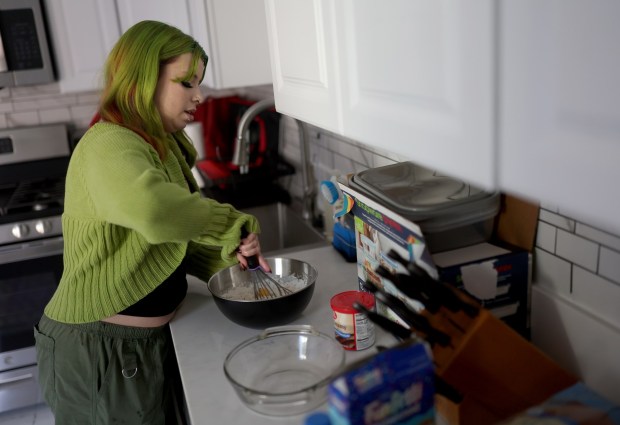 Stevie Steele, 22, bakes a cake at their new apartment in Antioch, Calif., on Thursday, Oct. 30, 2025. Steele was provided assistance by Oakland-based First Place for Youth, a nonprofit which helps transition-age foster youth. (Jane Tyska/Bay Area News Group)