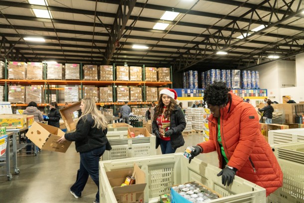 Volunteers fill boxes with an assortment of food to distribute at Sacramento Food Bank and Family Services on December 11, 2025. Roberta Alvarado, The OBSERVER