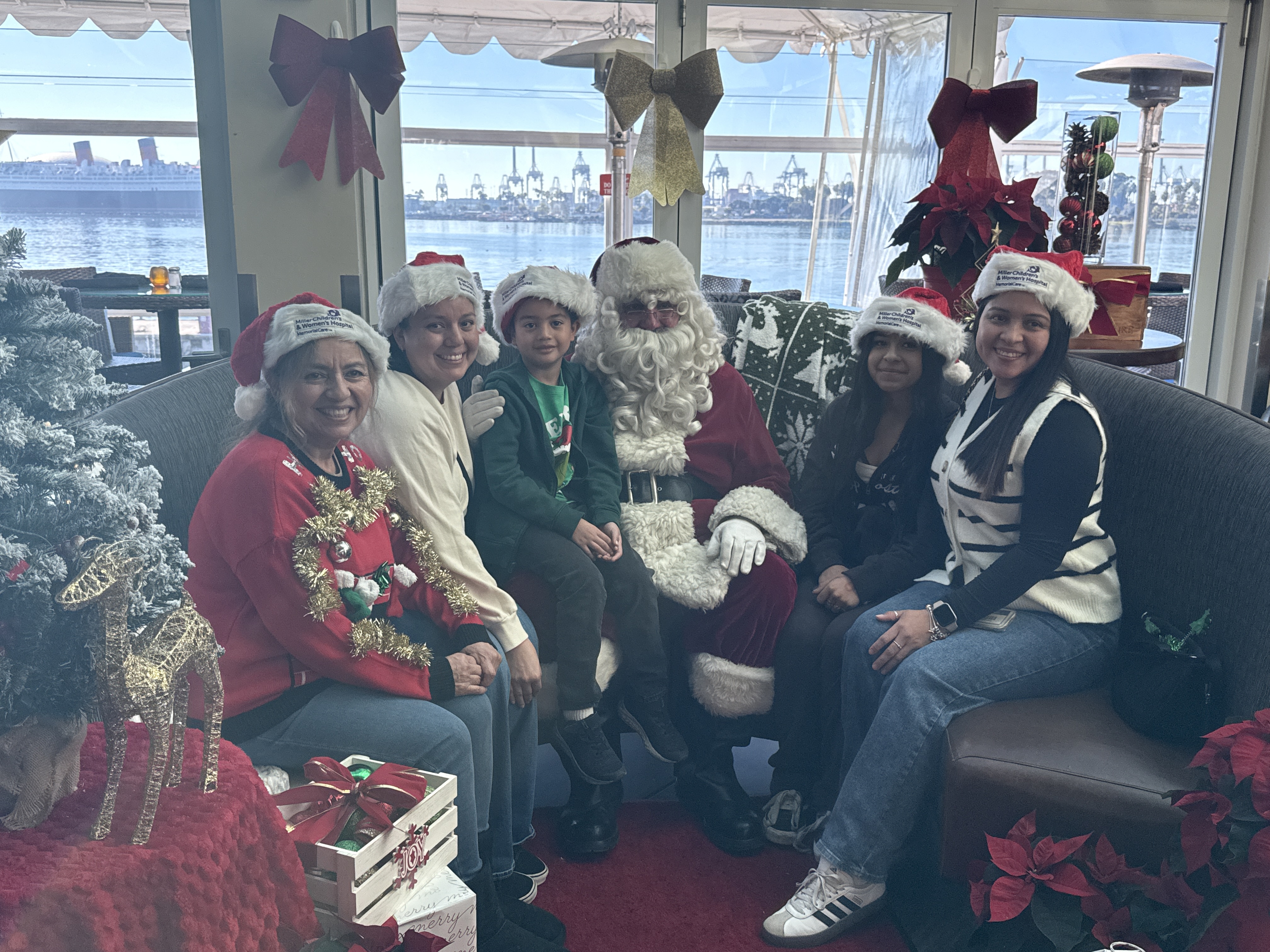 A local family gathers for a holiday photo with Santa...