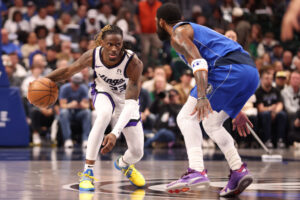 DALLAS, TEXAS - FEBRUARY 10: Keon Ellis #23 of the Sacramento Kings dribbles the ball against Kyrie Irving #11 of the Dallas Mavericks during the first quarter at American Airlines Center on February 10, 2025 in Dallas, Texas. NOTE TO USER: User expressly acknowledges and agrees that, by downloading and or using this photograph, User is consenting to the terms and conditions of the Getty Images License Agreement. (Photo by Tim Heitman/Getty Images)