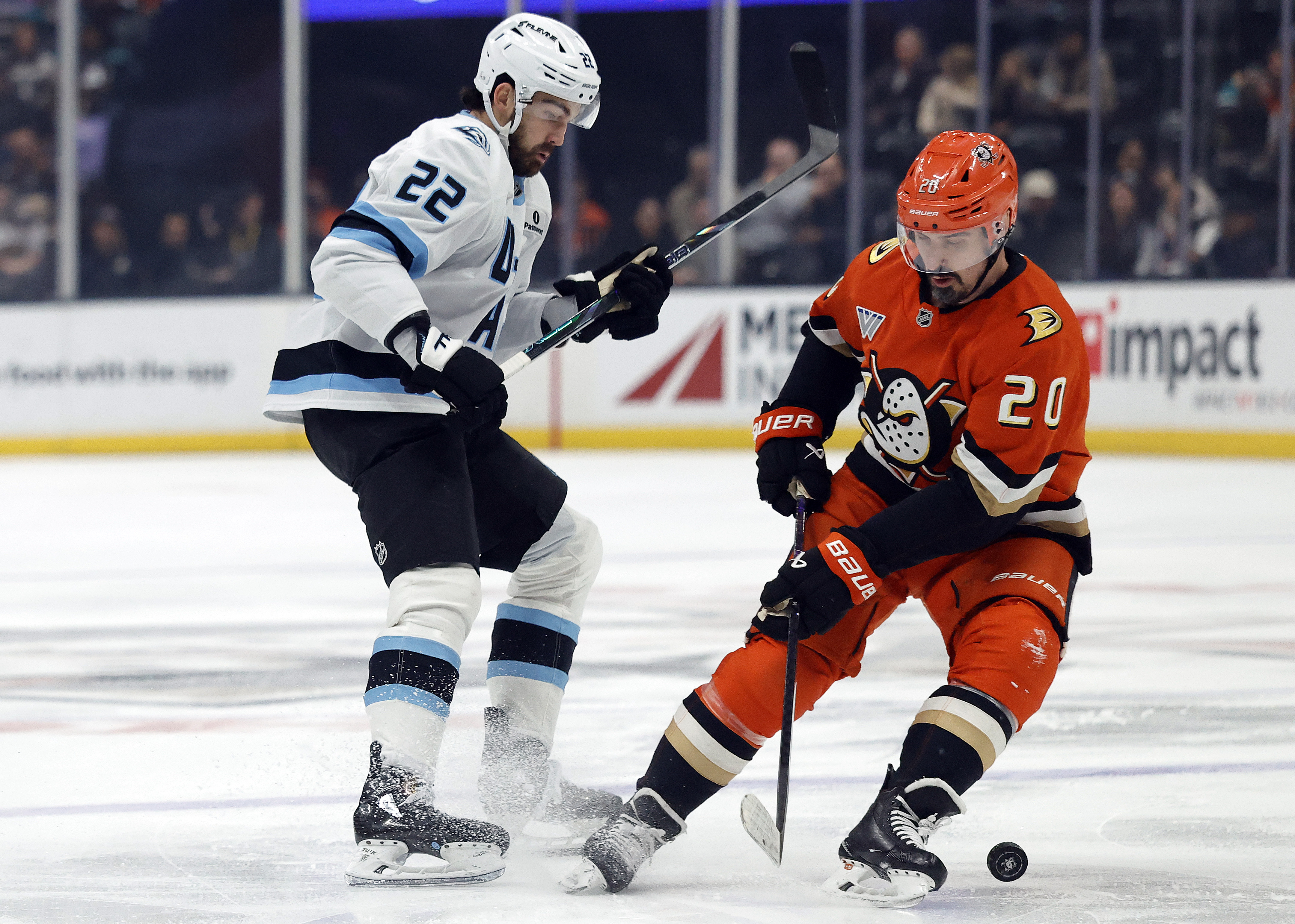 The Ducks’ Chris Kreider, right, skates the puck in front...