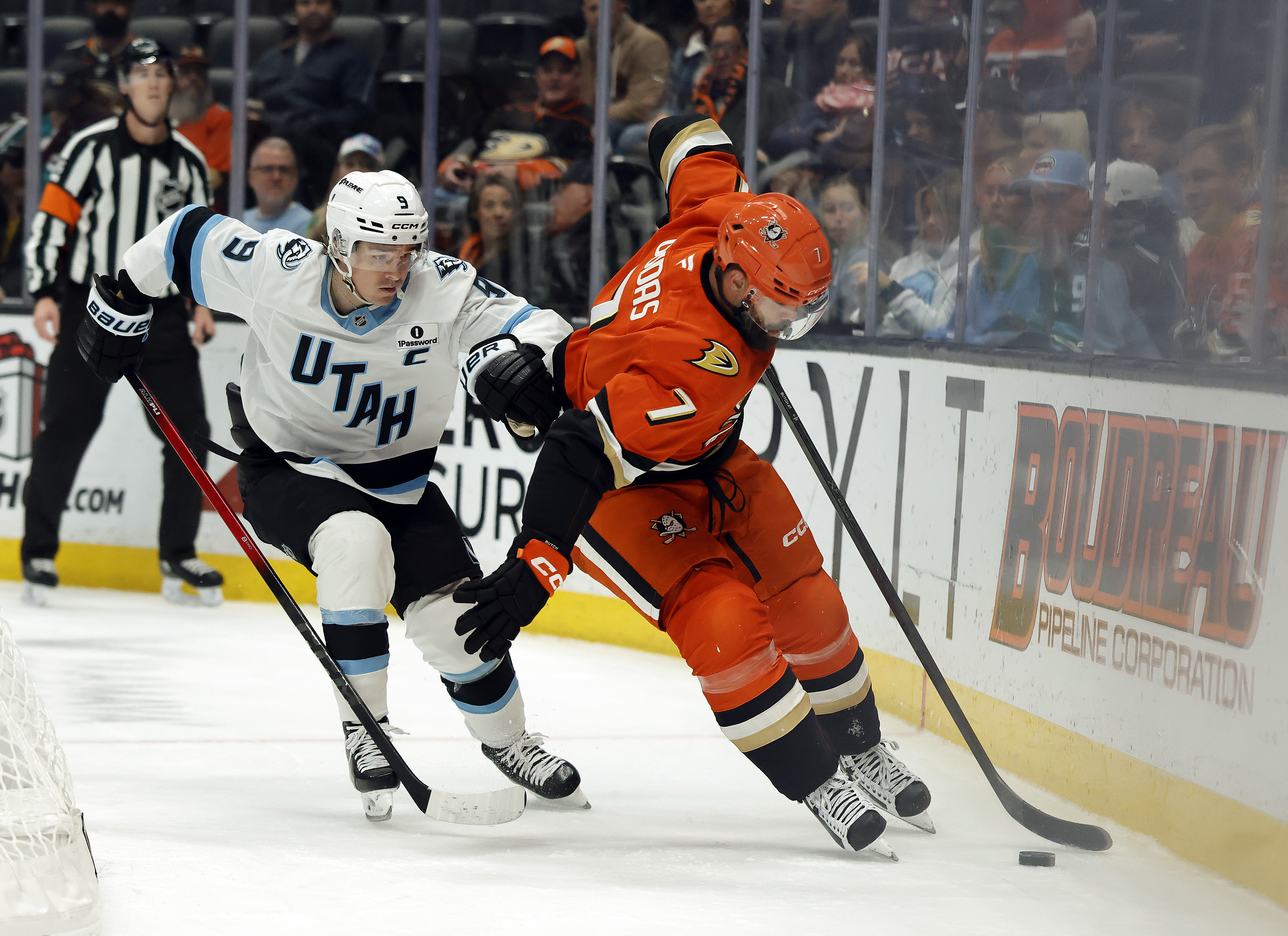 The Ducks’ Radko Gudas, right, skates the puck against the...