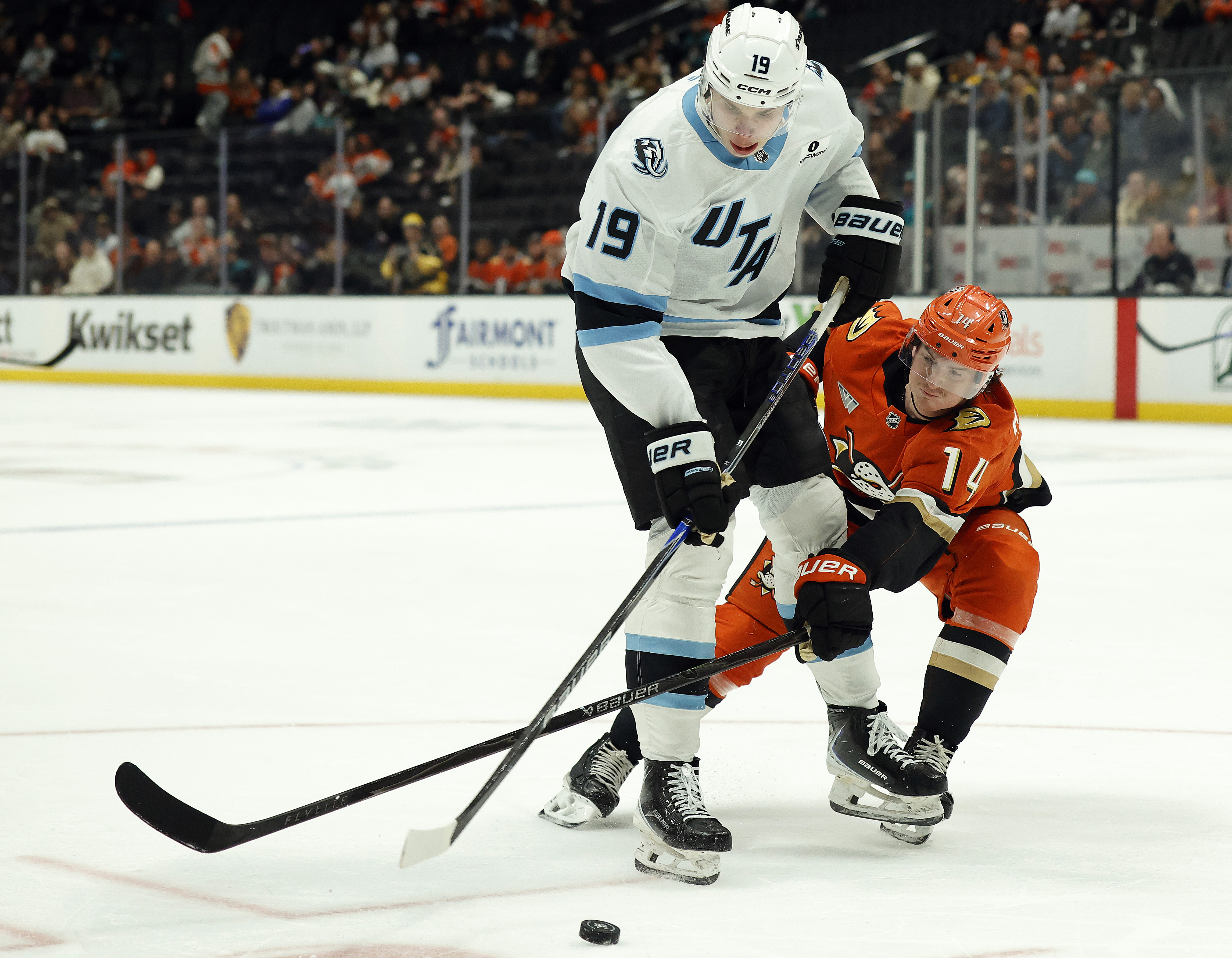 The Utah Mammoth’s Daniil But, left, skates the puck in...