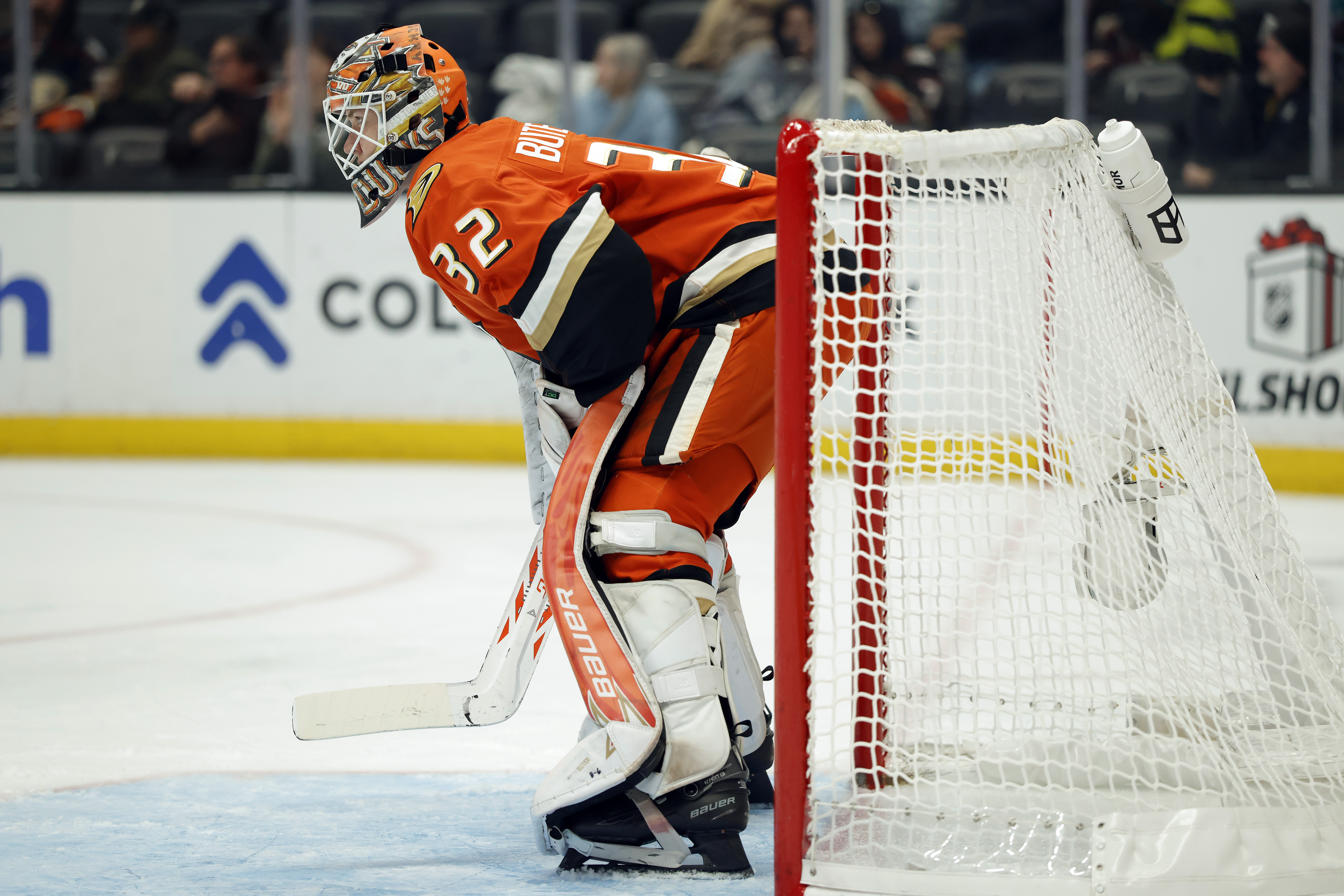 Ducks goaltender Vyacheslav Buteyets stands in front of his net...