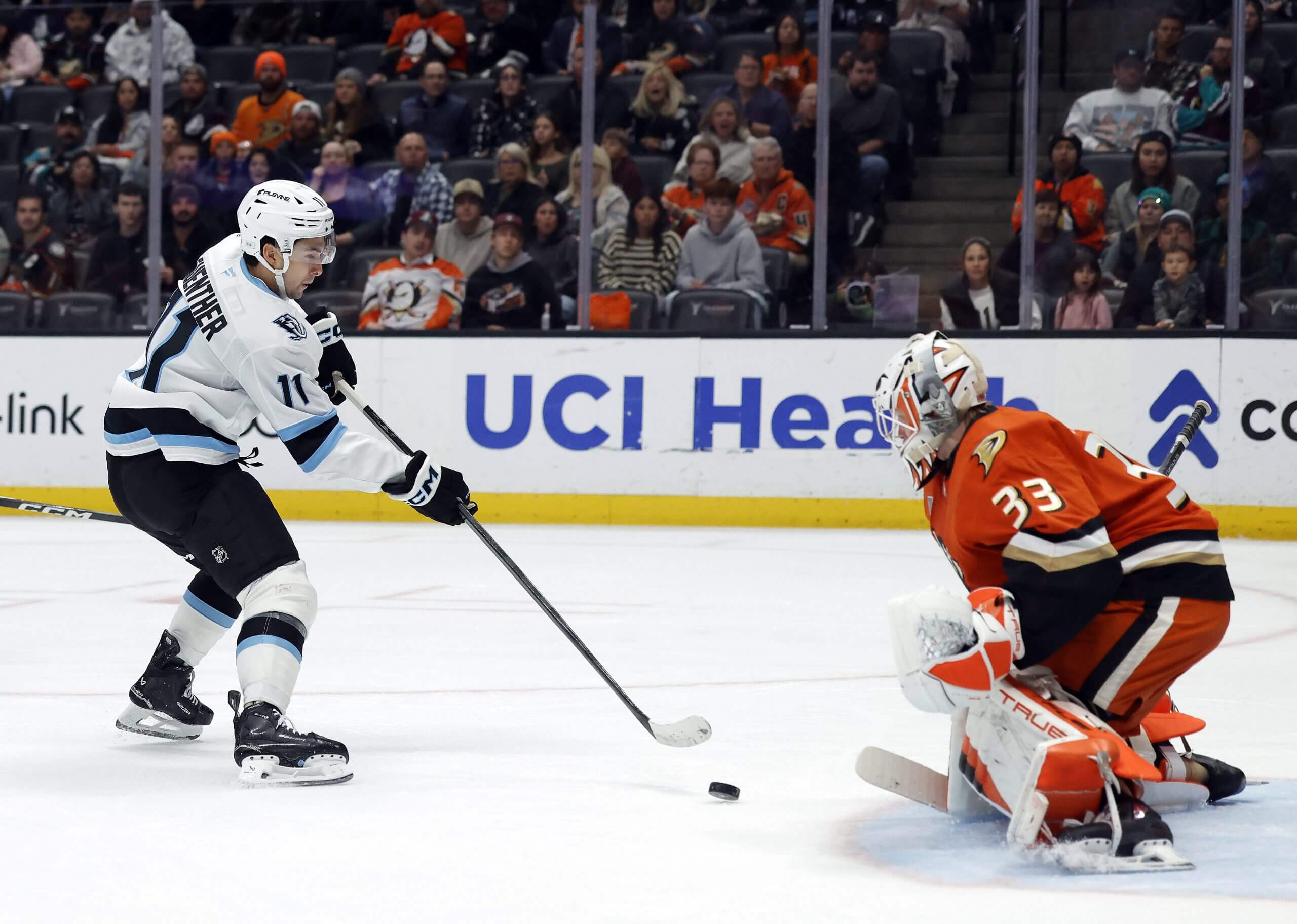 Ville Husso prepares for a shot from Utah's Dylan Guenther.