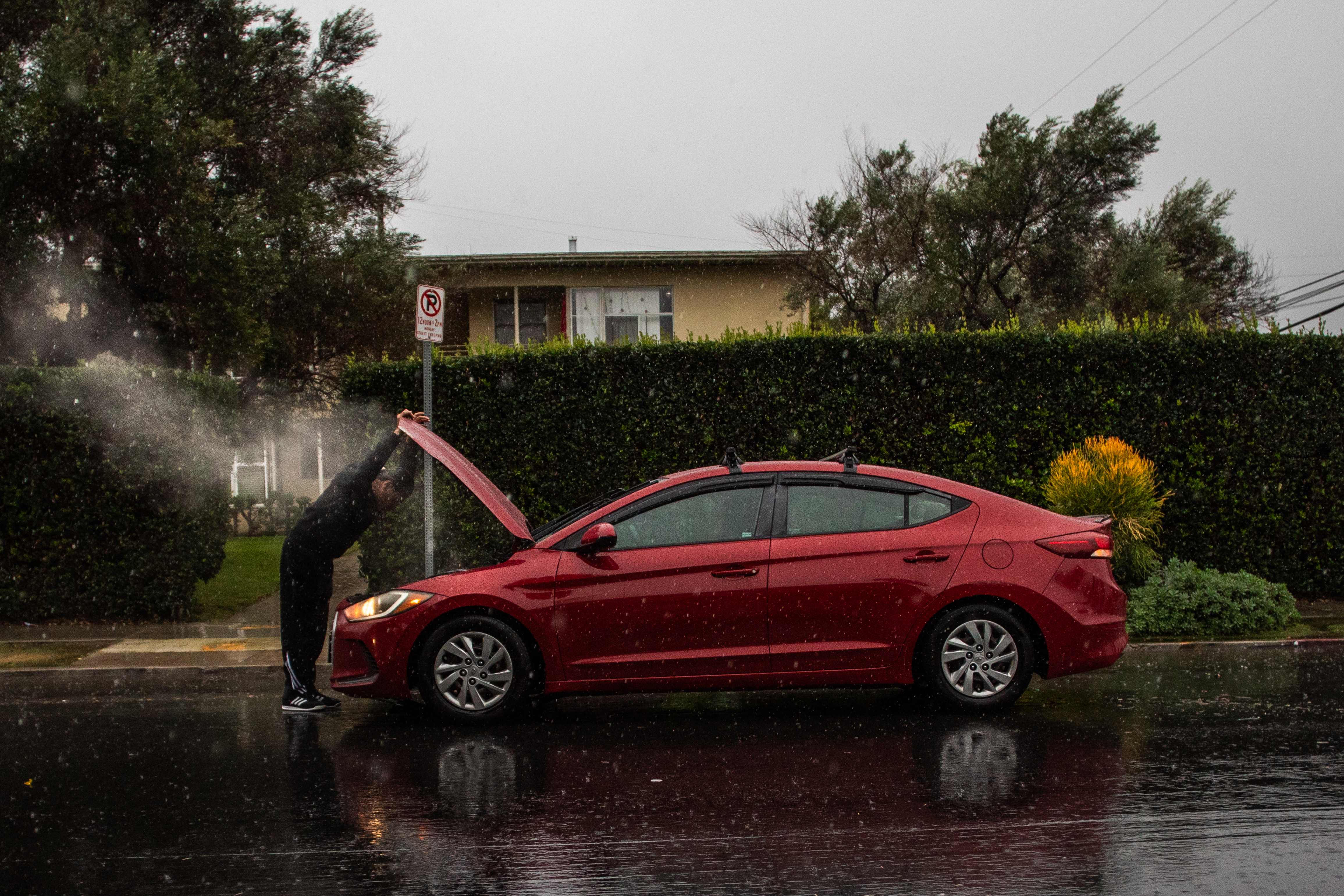 A man checks the damage caused by driving through a flooded road on La Cienega Boulevard on December 24, 2025 in Los Angeles, California. A major winter storm rolled into California on December 23, forcing hundreds of evacuations in burn areas while threatening flooding and travel delays through Christmas for much of the state, officials said.<br />
A “strong atmospheric river brings heavy rain, snow, and wind to California through Friday,” the National Weather Service said in a statement on December 23, warning anyone in northern, central and southern parts of the state to “exercise extreme caution.” (Photo by Apu GOMES / AFP via Getty Images)