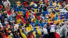 PASADENA , CA - JANUARY 02:  Parade goers endure the rain for a look at the  117th Tournament of Roses Parade on January 2, 2006 in Pasadena, California.  (Photo by Matthew Simmons/Getty Images)