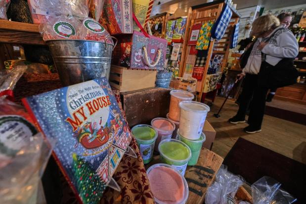 Post-holiday shoppers pass a seasonal candy and Christmas display