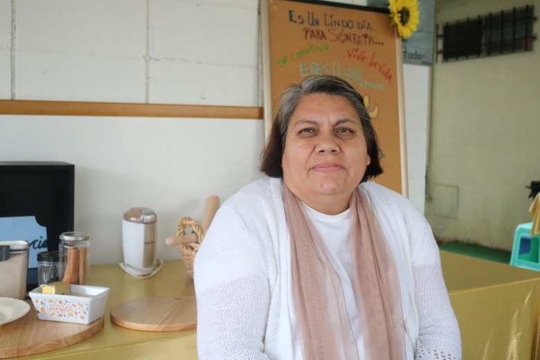 Guille Quezada, 53, poses for a photo on her front porch in Boyle Heights on Wednesday, Dec. 17, 2025.