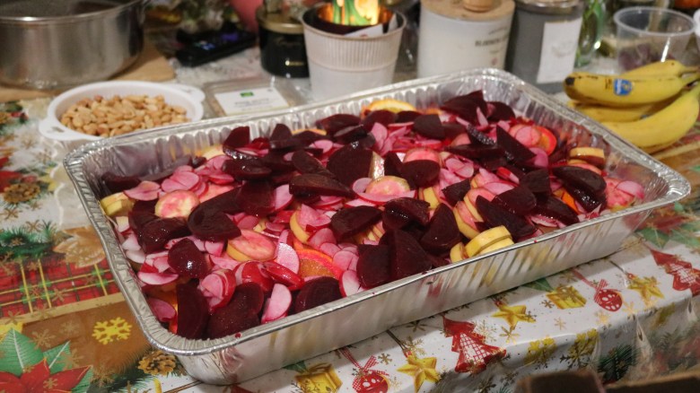 Noche Buena salad in an aluminum tray sits on a table. 