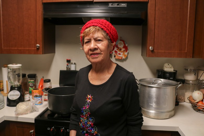 Letty Galvan poses for a photo inside her kitchen in Boyle Heights on Wednesday, Dec. 17, 2025.