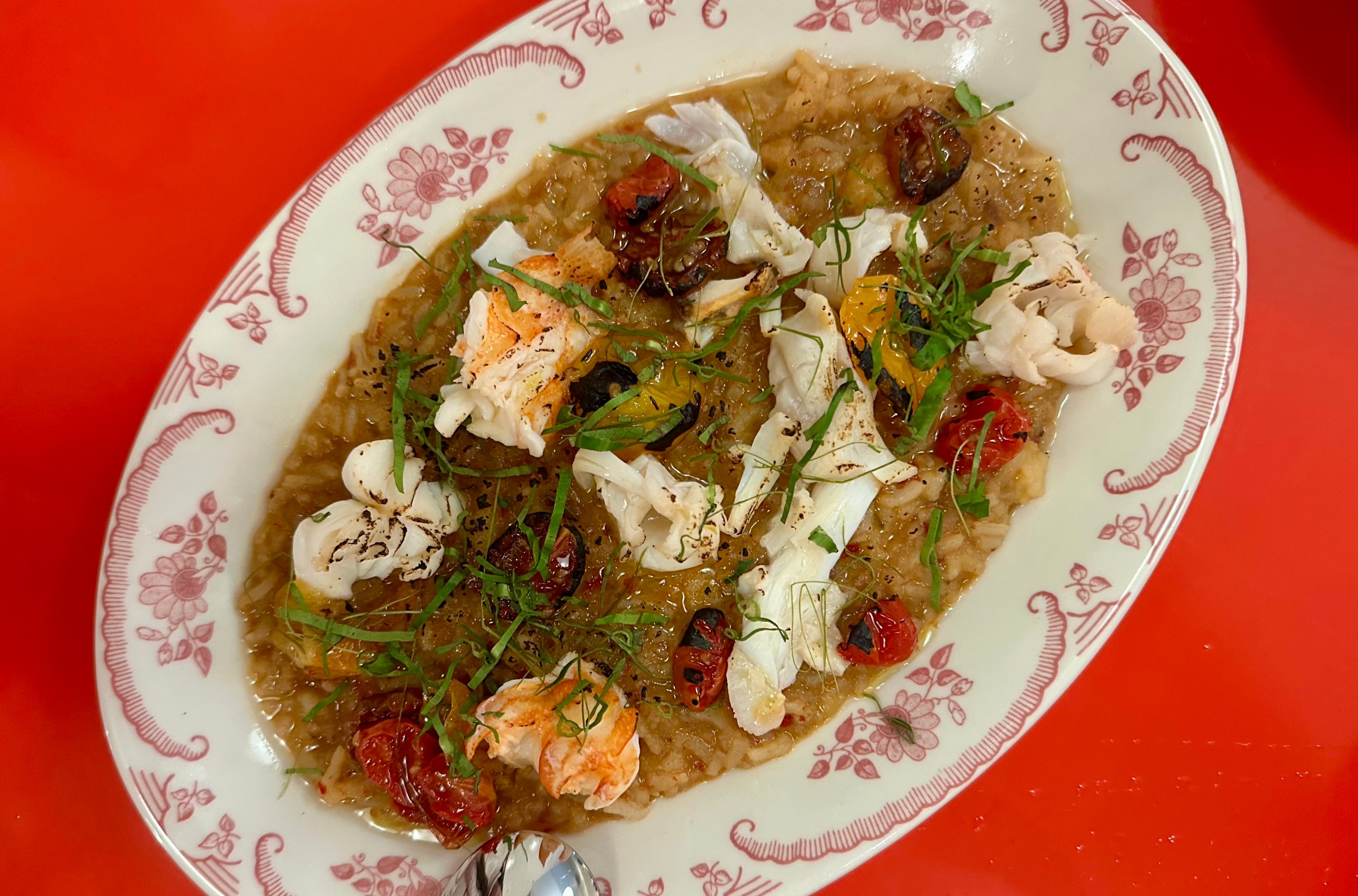 Beautifully plated tom yum-flavored risotto with spiny lobster morsels and herbs.