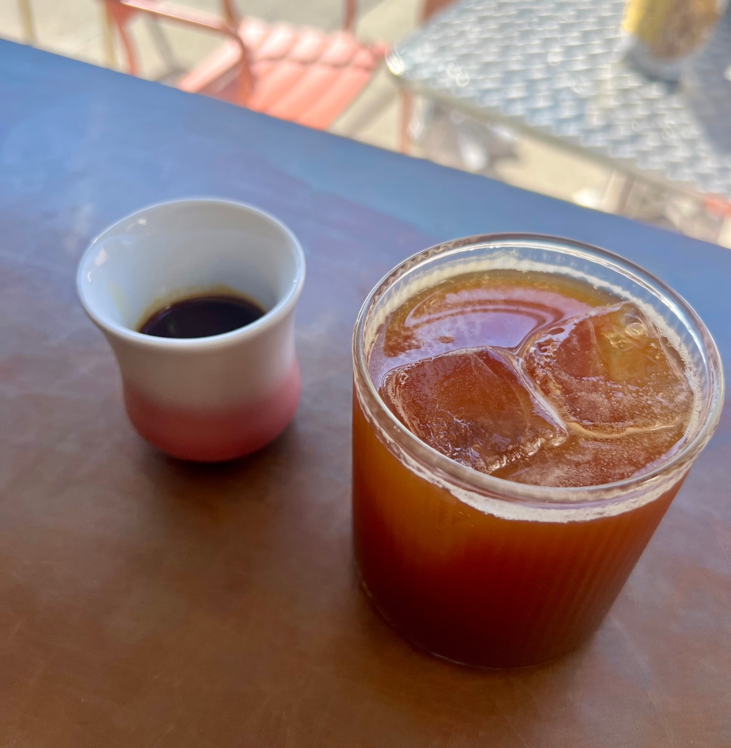 An iced coffee and a hot coffee.