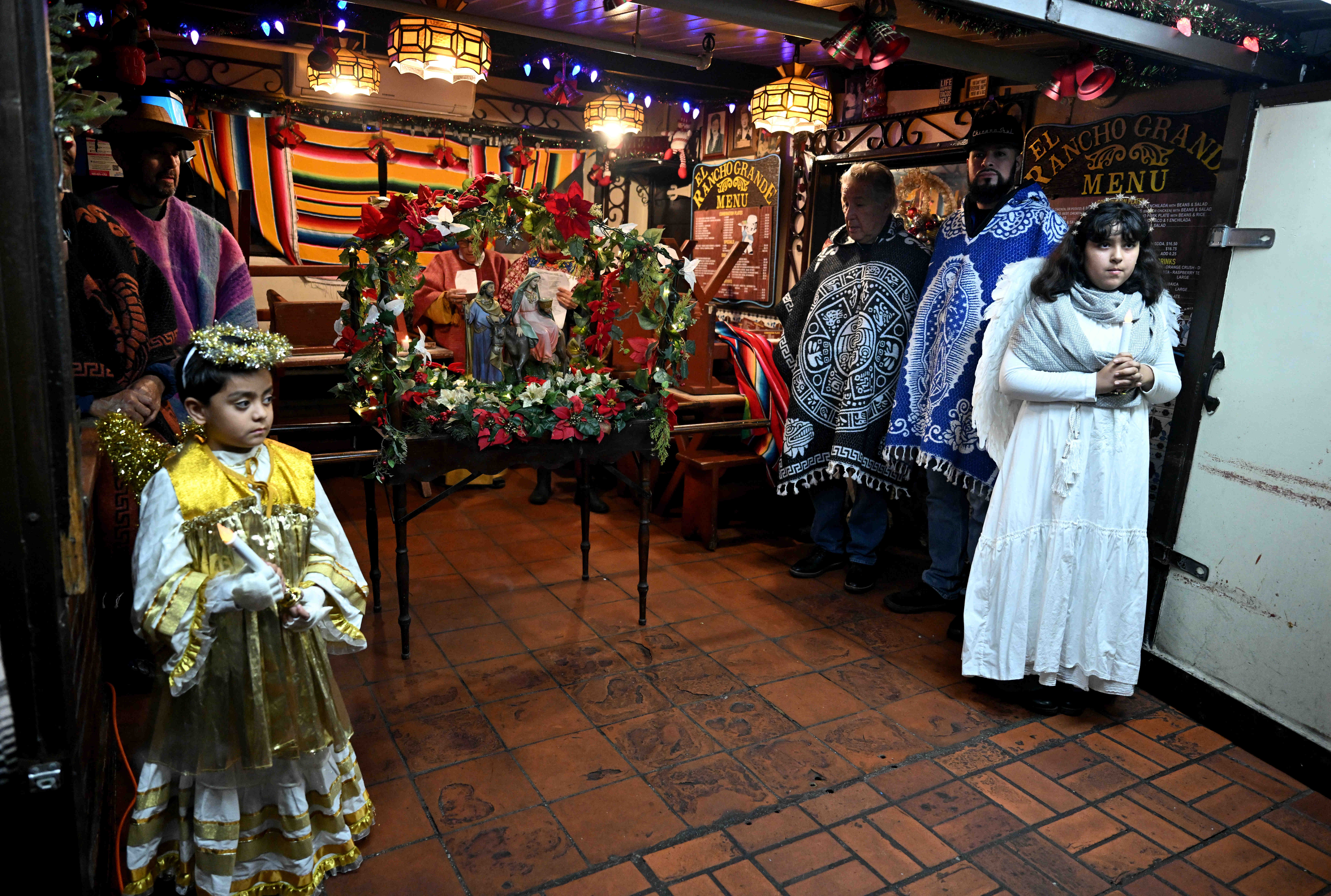 Las Posadas, reenacting the journey of Mary and Joseph to...