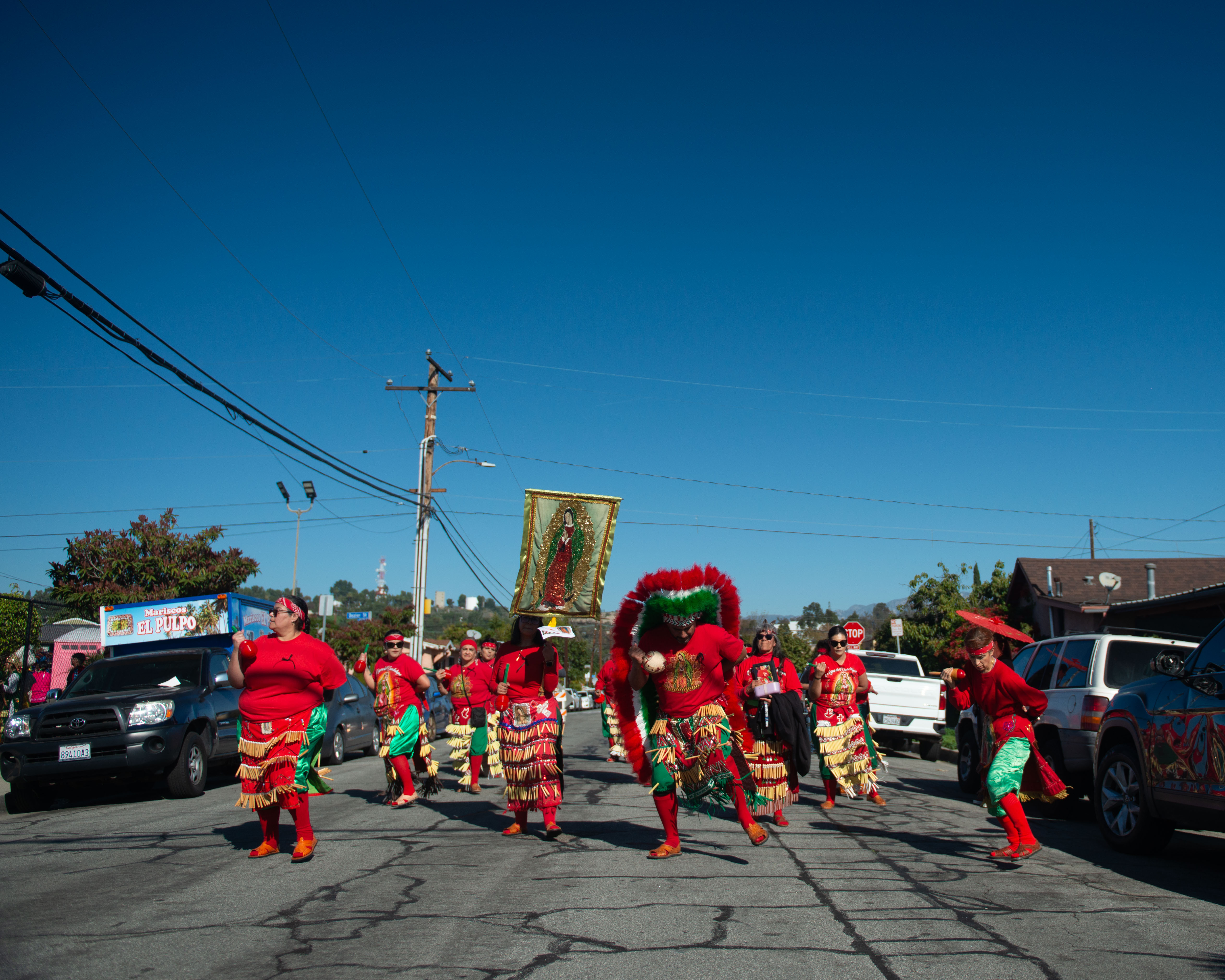 Members of one of the Danza Azteca groups dance in...