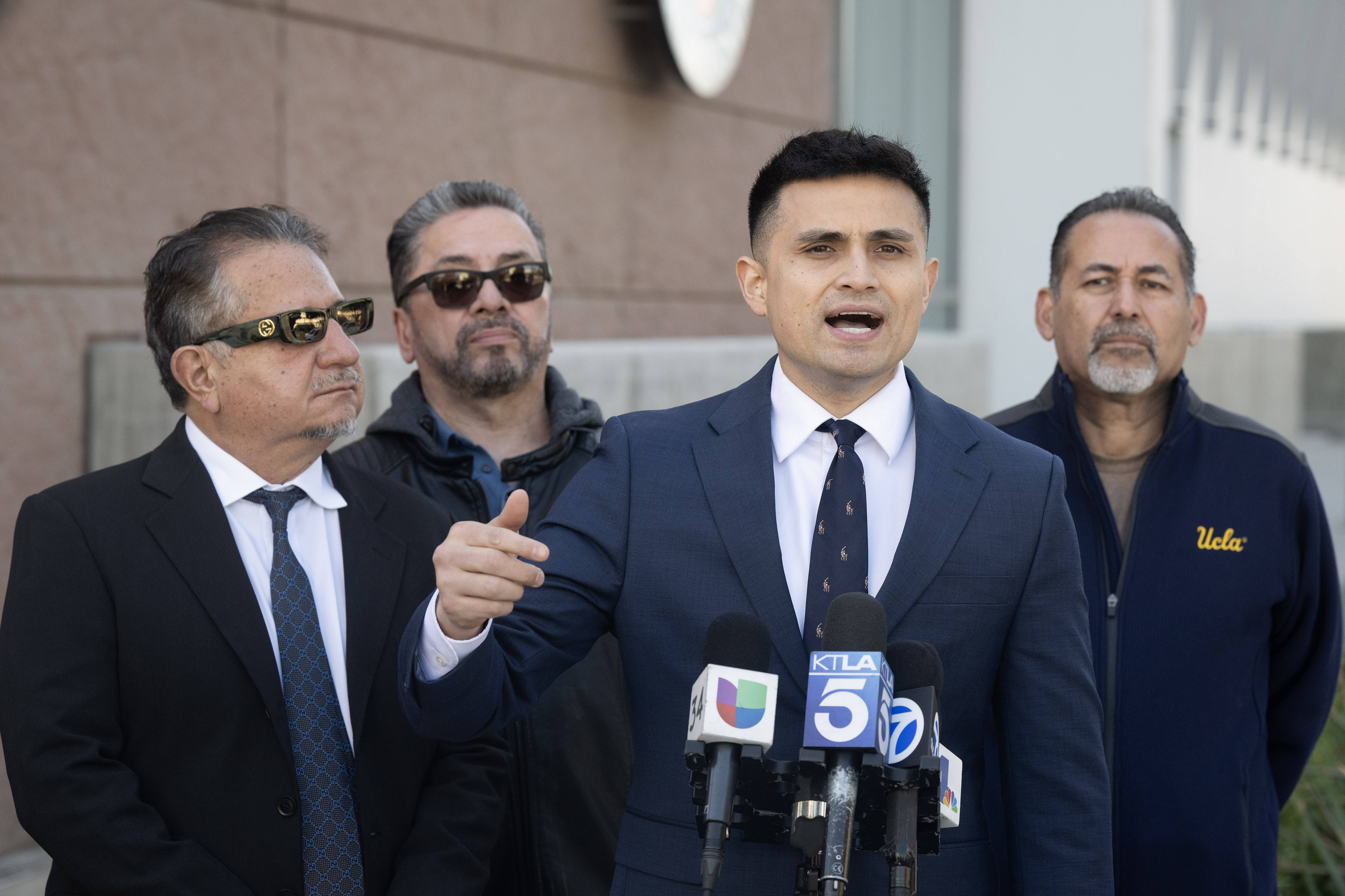 From left, attorney Humberto Guizar, father Jay Campos, attorney Christian...