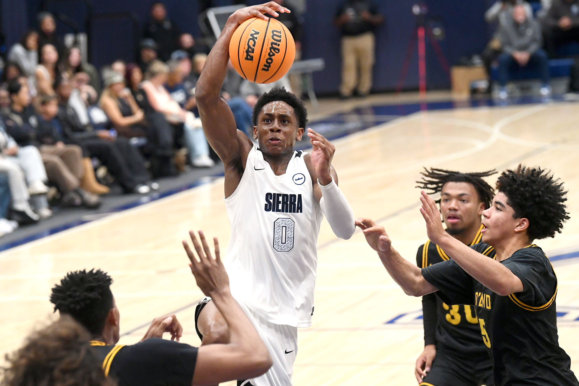 Sierra Canyonâs Brandon McCoy (0) gets by Bishop O’Dowd defenders...