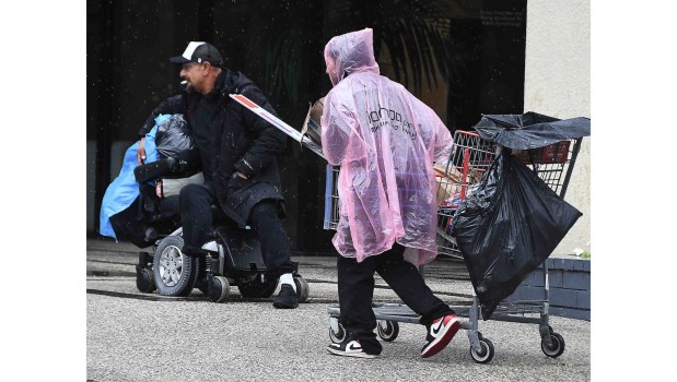 Homeless people have a tough time keeping dry on the third day of stormy weather in Southern California on Monday, in Sherman Oaks, Nov 17, 2025. (Photo by Gene Blevins, Contributing Photographer)