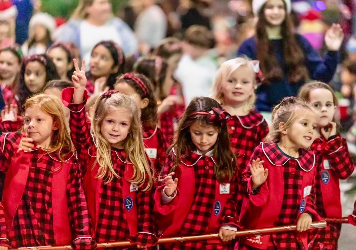 Members of Camp Fire Long Beach, wearing matching red plaid...
